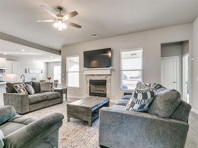 Living room with a fireplace and ceiling fan