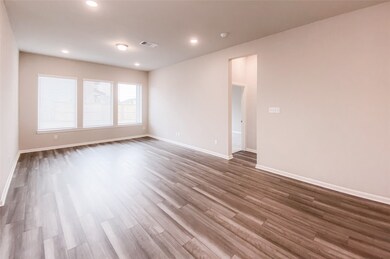 Spacious family room has large windows letting in lots of natural light
