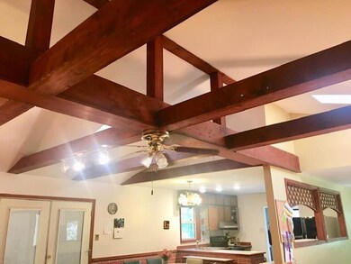 High beamed ceiling in your great room which is open to the kitchen and dining room.