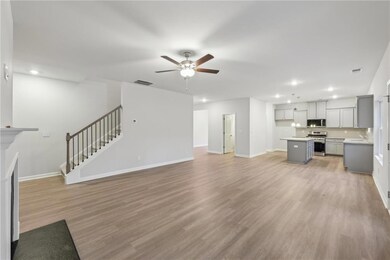 Unfurnished living room with recessed lighting, ba