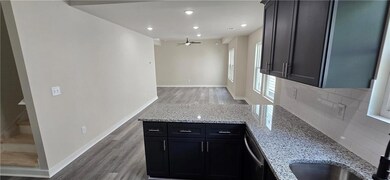 Kitchen featuring a peninsula, ceiling fan, light 