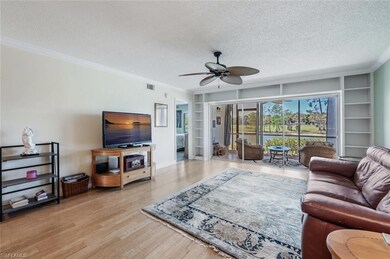 Living area with a textured ceiling, visible vents