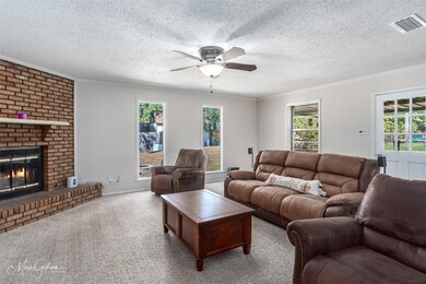 Living room with a wealth of natural light, a bric