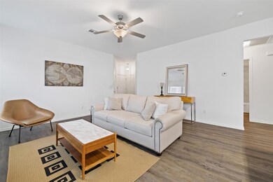 Living room with a ceiling fan and wood finished 