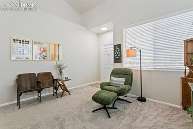 Sitting room with carpet flooring, vaulted ceiling, and baseboards