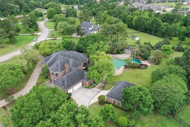 This photo will show the attached 3 car garage and the detached garage. The detached garage measures 35' x 25'. It features climate control, a 2 car garage door as well as a residential type exterior door.  Currently used as an office.