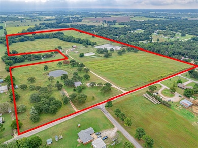 Aerial view of sparsely populated area featuring property boundaries highlighted