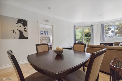 Dining space with crown molding, light tile patter