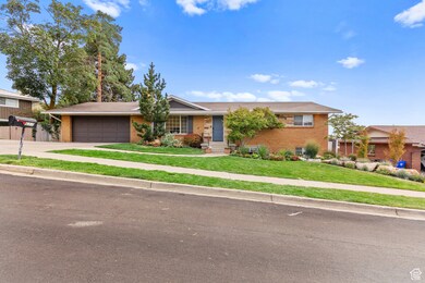 Ranch-style house featuring a front lawn, concrete driveway, brick siding, and an attached garage