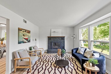 Bright and spacious living room featuring a wood-burning fireplace!