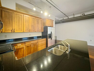 Kitchen with rail lighting, dark hardwood / wood-s