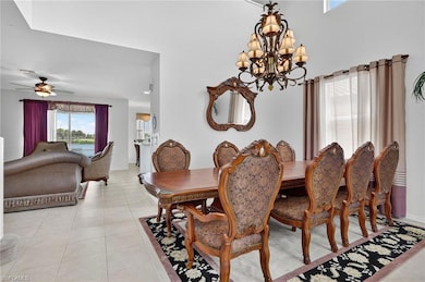 Dining space with light tile patterned floors and a chandelier