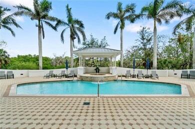 View of swimming pool with a gazebo and a pool with connected hot tub