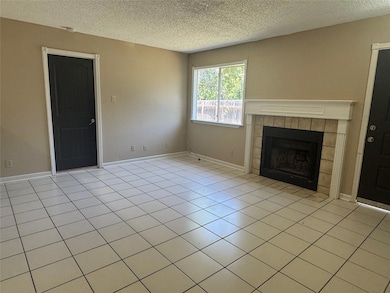 Unfurnished living room featuring a textured ceil