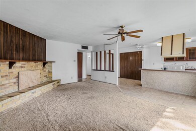 Unfurnished living room with wooden walls, sink, l