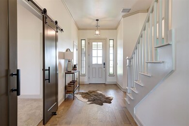 Foyer entrance featuring light hardwood / wood-sty