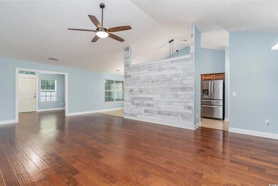 Unfurnished living room featuring ceiling fan, lig