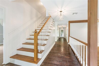Long foyer with the den to the right and dining ro
