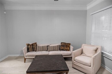 Living room with light wood-type flooring and crow