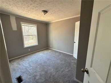 Carpeted spare room with baseboards, visible vents