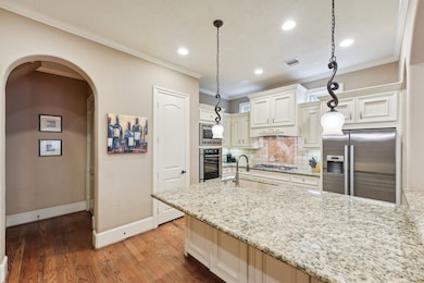 Gourmet kitchen with granite countertops, pendant