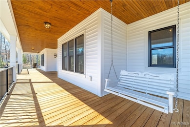 Wooden deck featuring covered porch