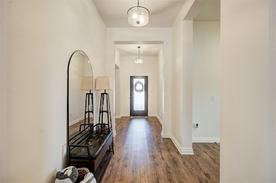 Foyer with an inviting chandelier and hardwood / wood-style floors
