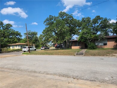 View of asphalt road with curbs and street lighting