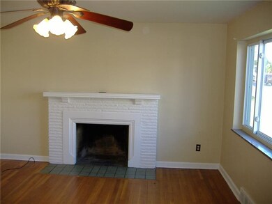 Living room has HW flooring, a wood burning firepl