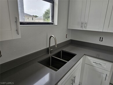 Kitchen with sink and white cabinets