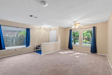 Unfurnished room with carpet floors, a ceiling fa