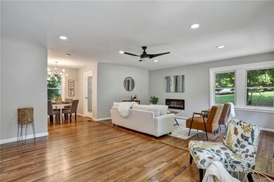 Living room featuring ceiling fan with notable cha