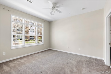 Unfurnished room featuring ceiling fan, baseboards