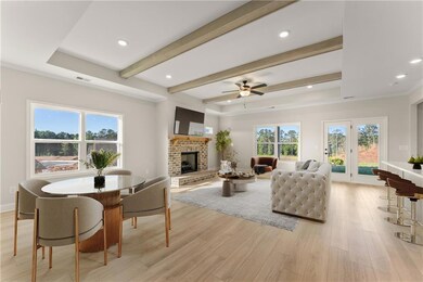 Living room with ceiling fan, a fireplace, and lig