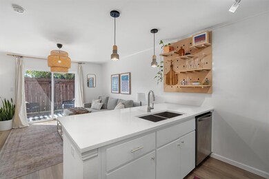 Kitchen featuring a sink, dishwasher, a peninsula