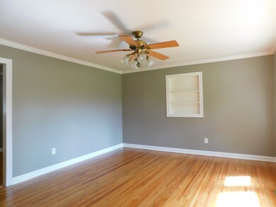 The living room boasts hardwood floors and natural lighting.
