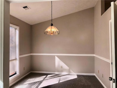 Unfurnished room featuring carpet and baseboards