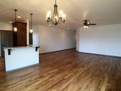 Large great room with oak hardwood flooring.