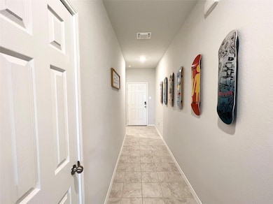 Hall featuring baseboards and light tile patterned flooring