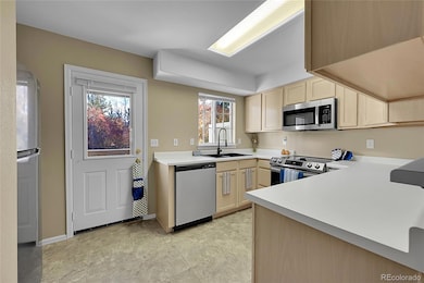 The updated kitchen features new sink, faucet, disposal and a view to the back deck and green space