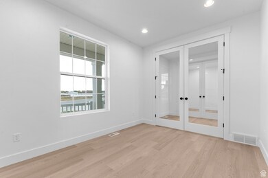 Spare room with french doors, recessed lighting, and light wood finished floors