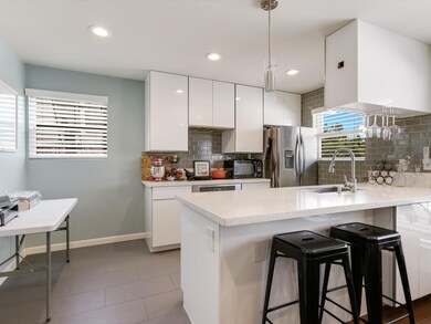 Kitchen featuring stainless steel refrigerator wi