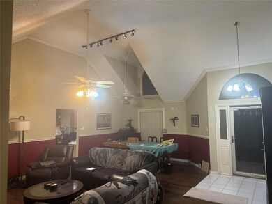 Living room with a textured ceiling, hardwood / wo