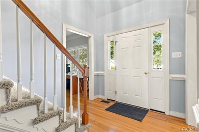 Gorgeous two story foyer with hardwood flooring an