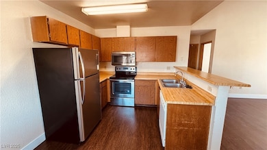 Kitchen featuring stainless steel appliances, a si