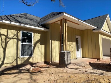 Front view. Hardy plank and stone wrapped column.