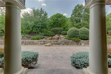 Stately porch that overlooks waterfall and lots of