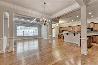 Kitchen with open floor plan, black microwave, backsplash, a kitchen bar, and crown molding