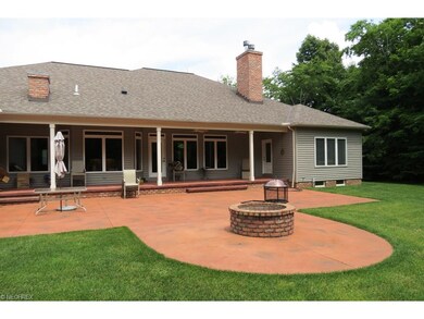 The rear features a covered porch wired for media 