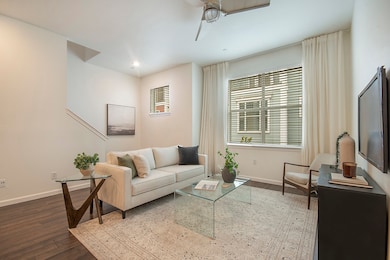 Main level living room with wood floors, plenty of natural light, and recessed lighting